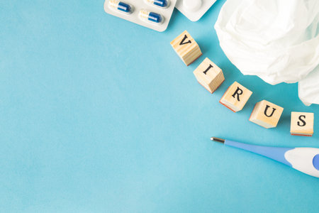 Selective focus on medical pills, used tissue and thermometer on blue