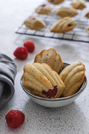 Close-up of raspberry handmade madeleine, traditional french small cake cookie on gray tableの写真素材