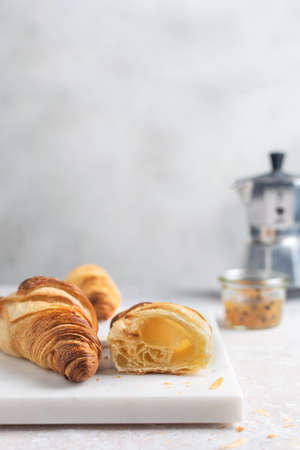 Minimal breakfast freshly baked growing with passion fruit jam on marble board, copy spaceの写真素材