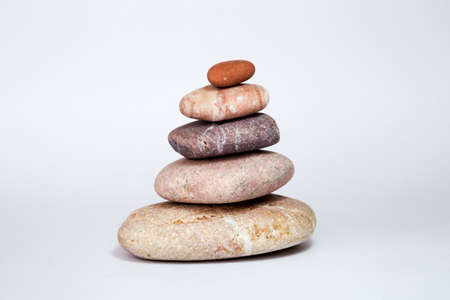 balance with five color stone row on the plain backgroundの写真素材