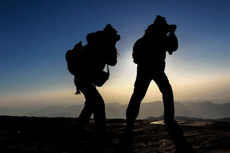 two silhoutte photographers in the mountain in Turkeyの写真素材