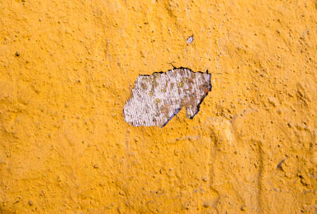 Cracked paint on the outer wall on the old buildingの写真素材