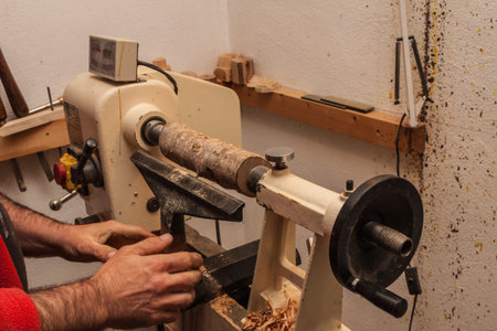 man hands working on wooden latheの写真素材