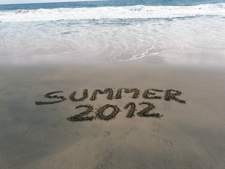 Summer 2012 phrase written on sand beach