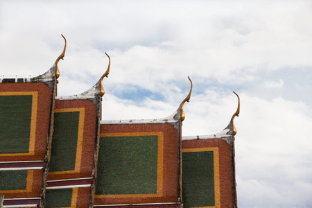 Buddhist temple roof of Thailand as a cloudy background