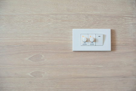 Two dimmer switch and one light switch on switchboard