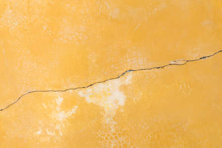 Old plaster wall yellow background.の写真素材