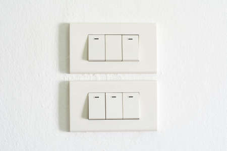 Light switch on white wallの写真素材