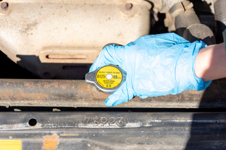 car radiator plug, car mechanic checking the level of antifreeze in the car engine, close-up