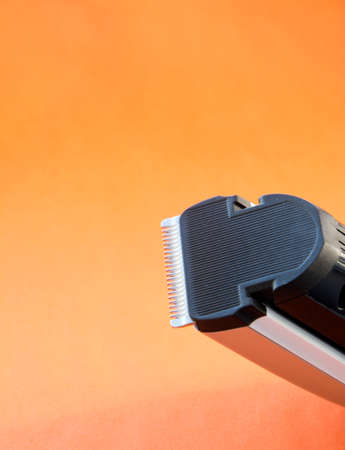 hair shearing machine on an orange backgroundの写真素材
