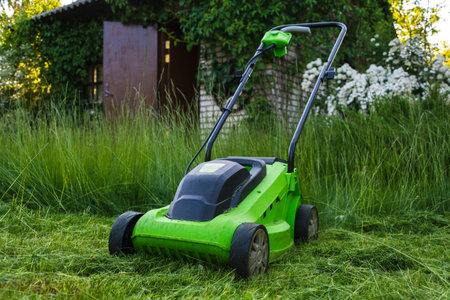 lawn mower on the grass, lawn care, mowing the grass, country cares, lawn mowing with an electric...