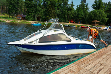 Speedboat with a motor at the pier, lake shore, fishing, active recreation, against the background...