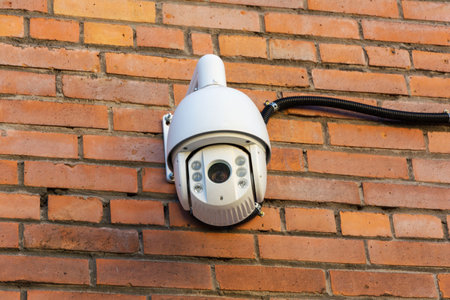 Video surveillance camera on the background of a brick wall. Security concept, video and photo surveillance. Tracking. Search. A place to copy. Protection of private property.の写真素材