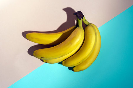 yellow bananas on a pink and turquoise background, pattern, minimalism, healthy food.