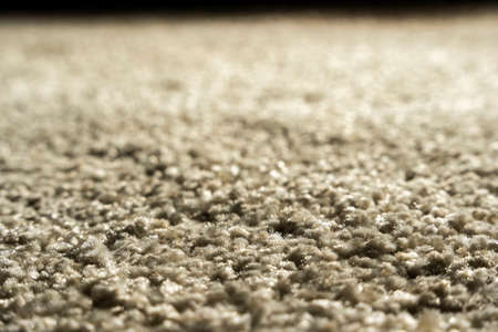 Close-up of beige fluffy carpet texture background, coffee-colored carpet background.の写真素材