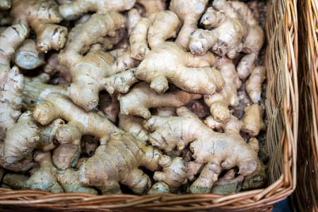 Ginger in a basket on the supermarket counter, sell ginger roots in a vegetable store.の写真素材
