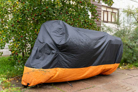 Motorcycle in the parking lot covered with a cover.の写真素材