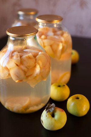 apple compote in glass jars on the kitchen table, soft evening light.の写真素材