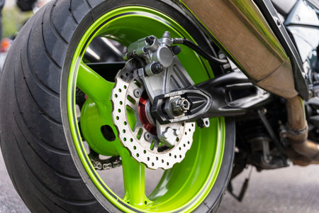 Motorcycle Rear Brake System, Brake Disc, Wheel, Brake Caliper, Rear Wheel, Motorcycle side view.