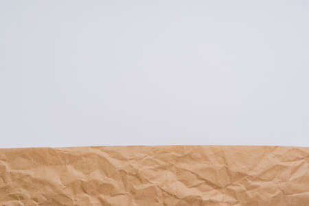 Background of crumpled wrapping paper and white space for copying text, beige rough sloppy creative background, wrapping paper textureの写真素材