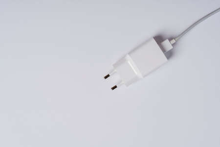 White phone charger close-up on a white background, copying space.の写真素材