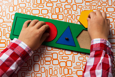 The child collects the sorter constructor. Puzzle sorter, an early development concept. Children's...