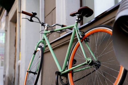 A city bike parked against the wall of a cafe in the city, Cycling to work, a stylish bike in an...