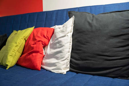 Colored pillows on a blue sofa, Living room furnitureの写真素材