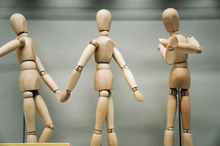 wooden figures of people holding hands, friendshipの写真素材