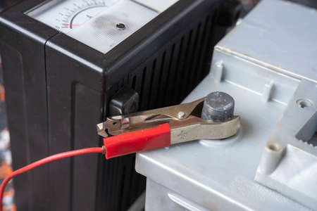 The process of charging the car accumulator, the terminal of the 12V car battery and the chargerの写真素材