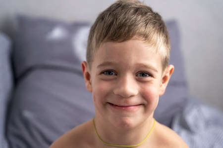 Portrait of a smiling cute Caucasian boy 5 years old who has just woken upの写真素材
