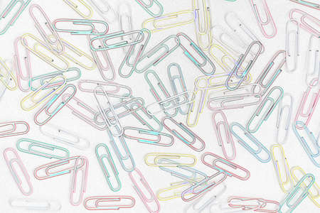 Cheerful background of colored paper clips on a white backgroundの写真素材