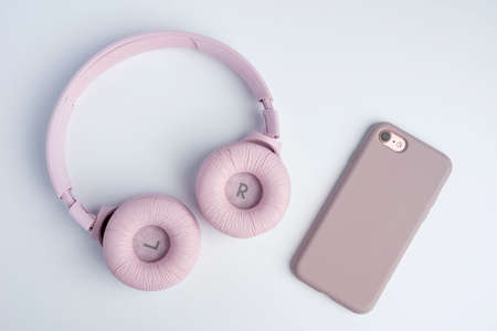 pink wireless headphones and a smartphone on a white background. Music time. space for text. Ready to listen to musicの写真素材
