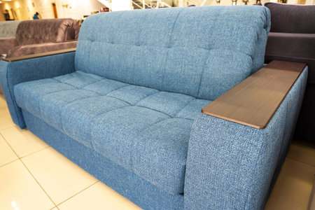 Soft new blue modern comfortable sofa with wooden armrest