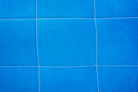 blue fabric backgroundbackground of blue fabric with stitchingの写真素材