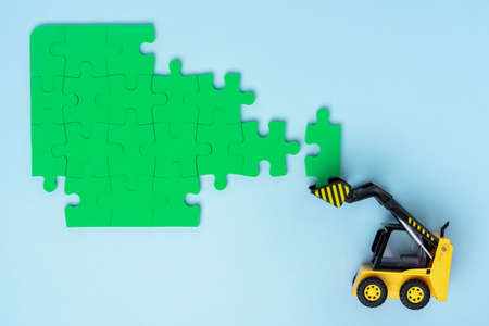 mini loader successfully folding puzzle on a white background.の写真素材