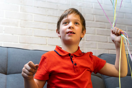 a happy preschool boy holds balloons in his hands