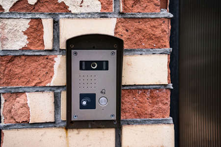 intercom panel with a video camera on the brick fence of private houseの写真素材