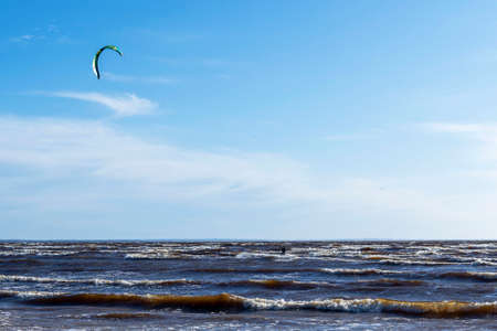 Kitesurfing at sea while performing tricks. freedom, strength, dreams.の写真素材