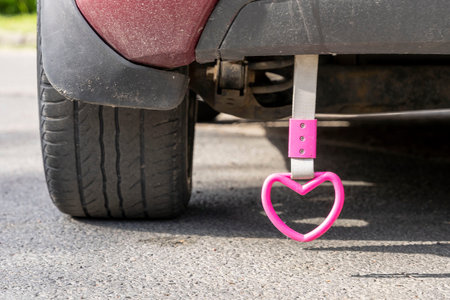 pink heart hanging on a rope on the back of the car