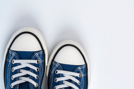a pair of blue sneakers on a white background. Fashionable youth shoes