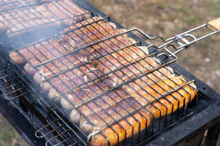BBQ sausages on the grill. Fried sausages, chevapchichi Meat product