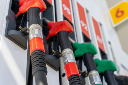 refueling pistols hang in a row at a gas station. side view from belowの写真素材