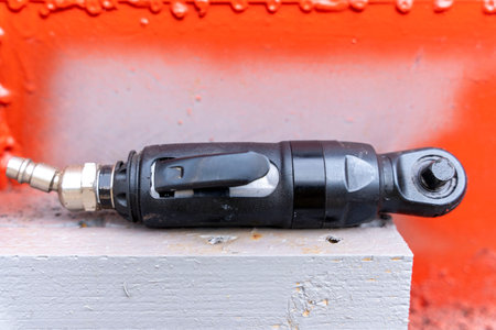 air ratchet wrench. angular pneumatic wrench on a gray background