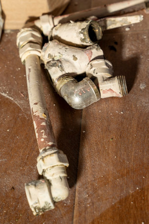 Old used pipes and fittings of old household plumbing. copper pipes for waterの写真素材