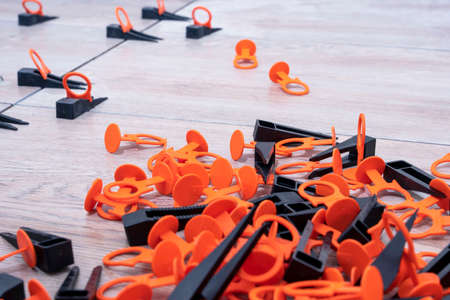 Tile leveling system with plastic clips and wedges. repair schoolの写真素材