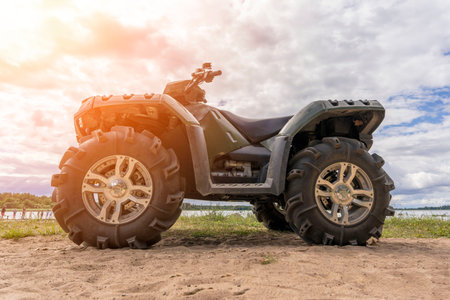 ATV on the sandy shore of the lake. side view.