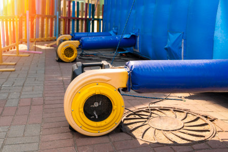 a blower for inflating a large trampoline in the parkの写真素材