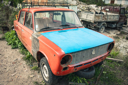 an old broken classic car abandoned on the street. stainless old machineの写真素材