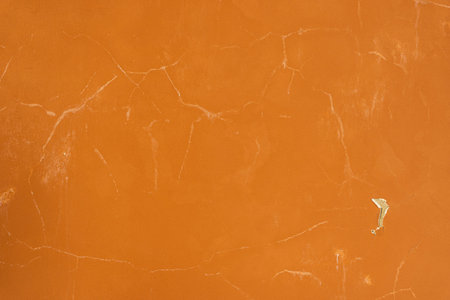 orange background of an old plastered wall in sunlight